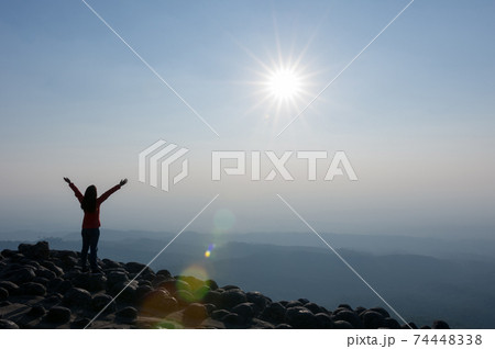 Woman on cliff of mountains. Woman on cliff of mountains. 74448338
