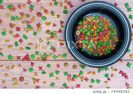 Cat food in bowl on wooden background 74448392