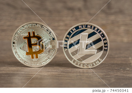 silver bitcoin and litecoin mettallic coins on wooden table silver bitcoin and litecoin mettallic coins on wooden table 74450341