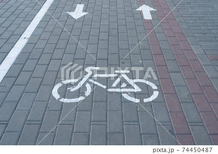 white bike road sign painted on asphalt white bike road sign painted on asphalt 74450487