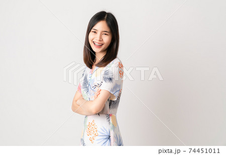 woman in light color dress and stand with crossed arms on white background. woman in light color dress and stand with crossed arms on white background. 74451011
