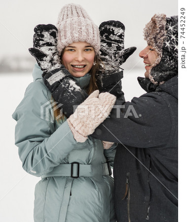 Portrait of smiling couple in love. Young happy couple walking in winter Portrait of smiling couple in love. Young happy couple walking in winter 74452249