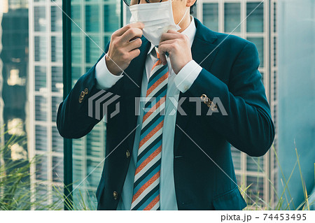 マスクのズレを直すビジネスマン 74453495