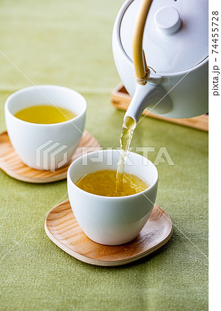 Cups of green tea and teapot. 74455728