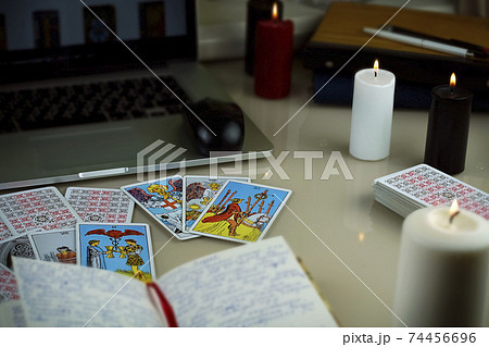 Blurred still life with Tarot cards layout on witch table. Esoteric Blurred still life with Tarot cards layout on witch table. Esoteric 74456696