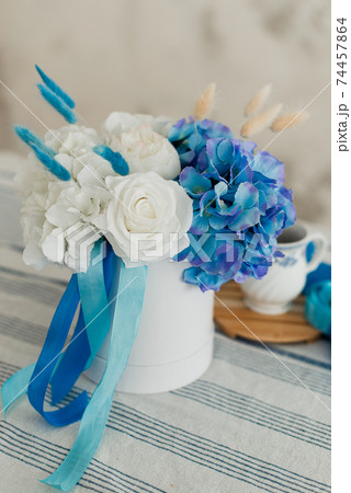 Artificial flowers. Decorative flowers as a gift. Flowers in a gift box. 74457864
