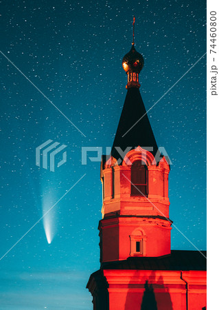 Korma Village, Dobrush District, Belarus. Comet Neowise C2020f3 In Night Starry Sky And St. John The Korma Convent Church In Korma Village. Famous Orthodox Church And Historic Heritage 74460800