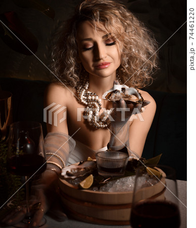 Portrait of blonde curly hair woman in white Portrait of blonde curly hair woman in white 74461220