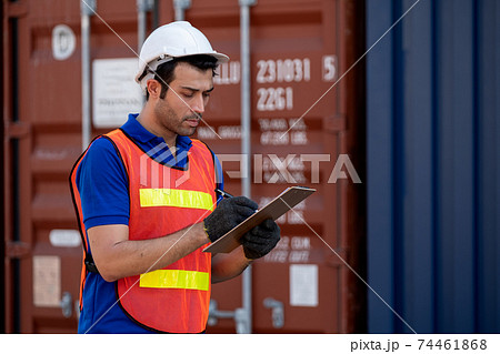 One foreman or engineer cargo container worker hold and record data in clipboard 74461868