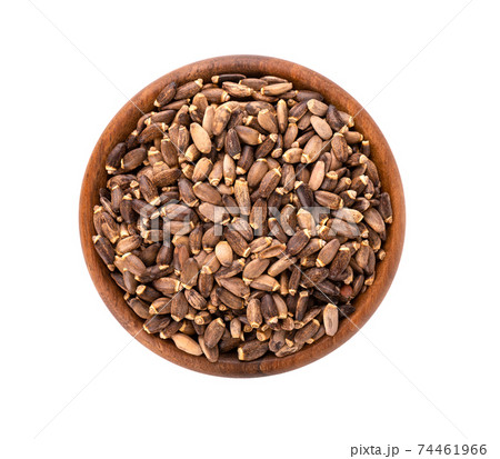 Milk Thistle seed in wooden bowl, isolated on white background. Silybum marianum, Scotch Thistle or Marian Thistle. Top view. 74461966