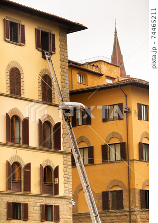 Lifting cargo to the top floor using a large staircase in the center of Florence.Italy.Tuscany Lifting cargo to the top floor using a large staircase in the center of Florence.Italy.Tuscany 74465211