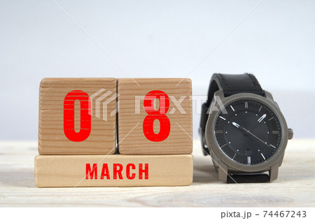 8 march, calendar on wooden blocks with wrist watch 74467243