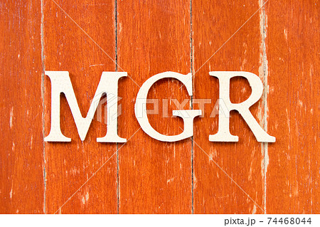 Alphabet letter in word mgr (abbreviation of manager) on old red color wood plate background 74468044