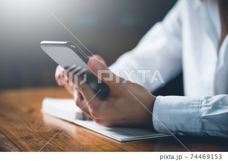 Close up of women's hand using cellphone or mobile for search website,data,social network with comunication.Business and finance concept. Close up of women's hand using cellphone or mobile for search website,data,social network with comunication.Business and finance concept. 74469153