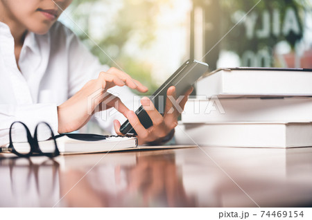 Close up of women's hand using cellphone or mobile for search website,data,social network with comunication.Business and finance concept. Close up of women's hand using cellphone or mobile for search website,data,social network with comunication.Business and finance concept. 74469154