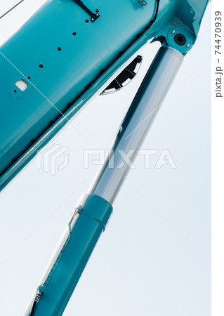 Hydraulic cylinder of the lifting system on a car crane.The control system of the crane engine.Lifting the hydraulic compartment on a truck crane. 74470939