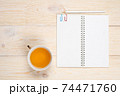 empty notebook with tea cup on white wooden table 74471760