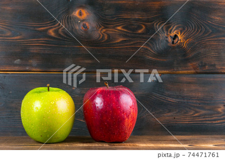 ripe juicy red and green apples on rustic wooden table 74471761