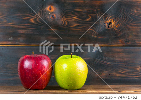 ripe juicy red and green apples on rustic wooden table 74471762