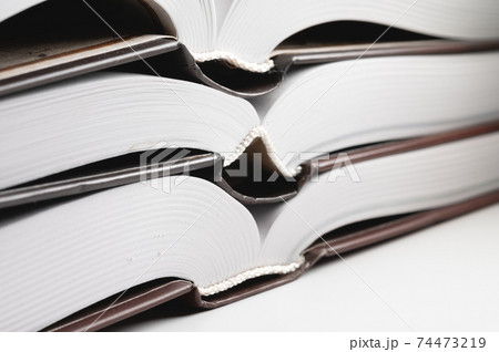 Binding of a new book. Close-up of a layer of pages. Library background Binding of a new book. Close-up of a layer of pages. Library background 74473219