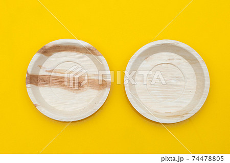 Betel palm leaf plates on yellow background. Betel palm leaf plates on yellow background. 74478805