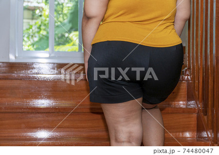 Unhealthy oversized problem concept. Back of obesity fat young woman walking upstairs 74480047