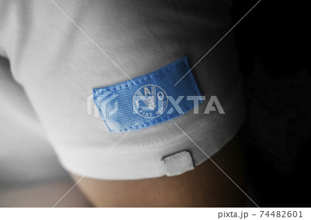 Patch of the national flag of the Food and agriculture organization on a white t-shirt 74482601