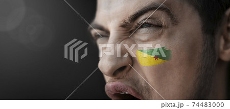 A screaming man with the image of the French Guiana national flag on his face A screaming man with the image of the French Guiana national flag on his face 74483000