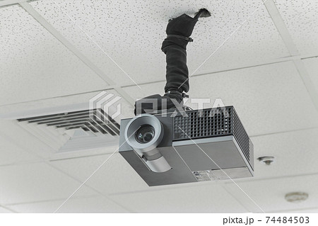 A black overhead projector on ceiling indoors. 74484503