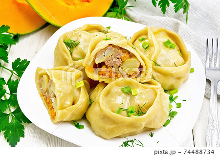 Manty with meat and pumpkin in plate on light board Manty with meat and pumpkin in plate on light board 74488734