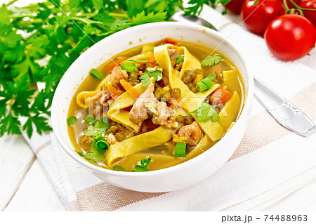 Soup with mung and noodles in bowl on light board Soup with mung and noodles in bowl on light board 74488963