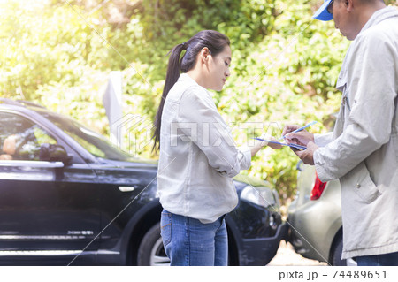 Car accident Car crash The woman talking to Insurance agent about the accident. Insurance agent writing document on clipboard of the incident for claim process. Transportation concept. Car accident Car crash The woman talking to Insurance agent about the accident. Insurance agent writing document on clipboard of the incident for claim process. Transportation concept. 74489651
