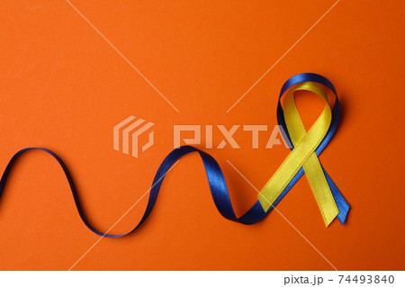Down Syndrome awareness ribbons on orange background Down Syndrome awareness ribbons on orange background 74493840