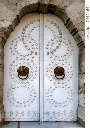 Old vintage white door with circles in Istanbul 74494644