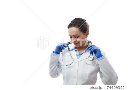 Confident doctor with stethoscope on his neck isolated on white background. Healthcare and medical concept. Copy space Confident doctor with stethoscope on his neck isolated on white background. Healthcare and medical concept. Copy space 74499392