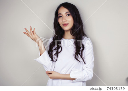 young asian woman doctor in white uniform gesturing positive on gray background, lifestyle healthcare people concept 74503179