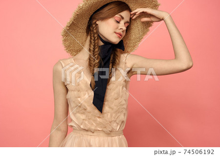 Beautiful woman in hat and in black dress ribbon portrait pink background model 74506192