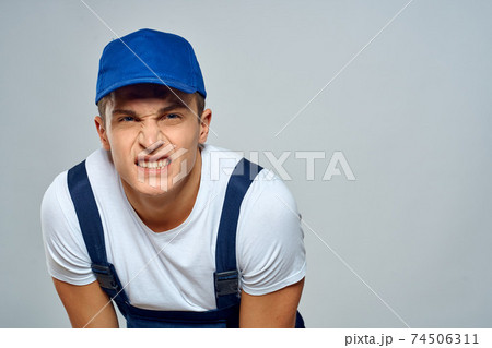 Man worker in forklift uniform delivery service light background Man worker in forklift uniform delivery service light background 74506311