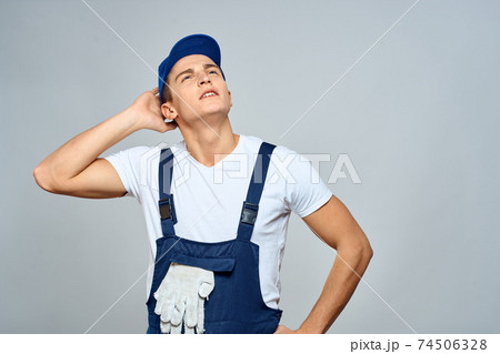 working man in uniform service lifestyle delivery service light background 74506328
