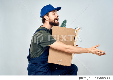 Male worker loading delivery boxes in hands packing lifestyle Male worker loading delivery boxes in hands packing lifestyle 74506934
