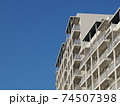 青空を背景にした白いマンション 74507398