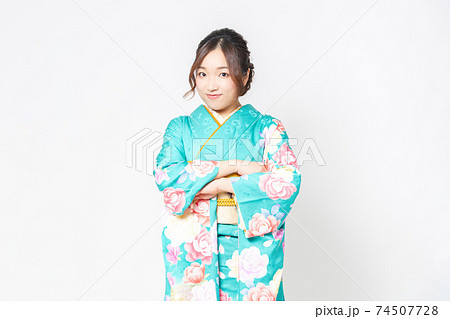 白背景の前で腕組みをする振袖を着た女性の写真素材