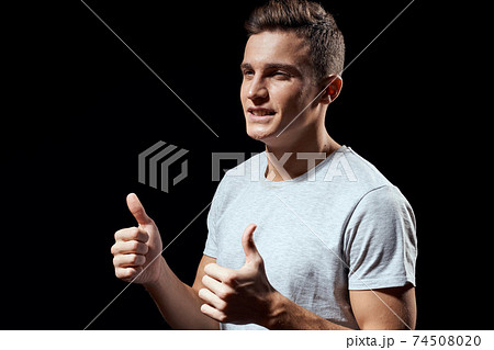handsome man in white t-shirt on black background inflated arm muscles sport model cropped view Copy Space handsome man in white t-shirt on black background inflated arm muscles sport model cropped view Copy Space 74508020