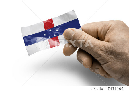 Hand holding a card with a national flag the Netherlands Antilles 74511064