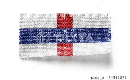 Netherlands Antilles flag on a piece of cloth on a white background 74511071