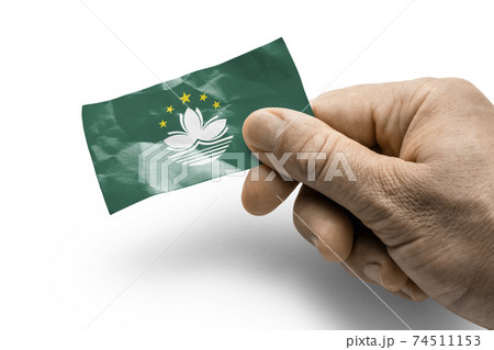 Hand holding a card with a national flag the Macao 74511153