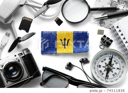 Flag of Barbados and travel accessories on a white background. Flag of Barbados and travel accessories on a white background. 74511836