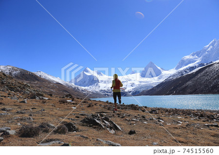 Woman trail runner cross country running  in winter mountains 74515560