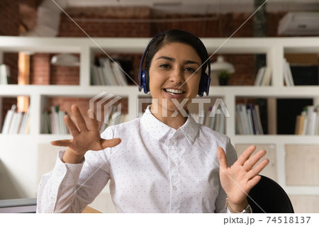 Portrait of smiling Indian woman talk on video call 74518137