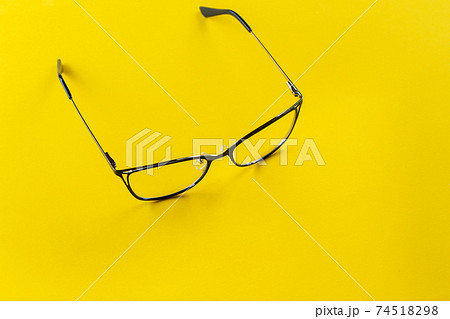 Stylish glasses on a yellow background. 74518298